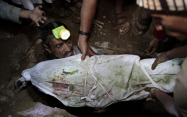 Nasser al-Salmi, left, buries his 10-year-old son Youssef, who was killed when a bomb exploded while he was playing with it near his family's house, in Hasn Faj Attan village, on the mountainous outskirts of Sanaa, Yemen, July, 24, 2016. (AP/Hani Mohammed)
