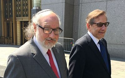 Jonathan Pollard (left), and his lawyer Eliot Lauer leave federal court in New York following a hearing, July 22, 2016. (AP/Larry Neumeister, File)