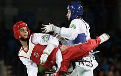 Ahmad Abughaush, of Jordan, left, battles Alexey Denisenko of Russia, in men's 68-kg taekwondo gold medal match at the 2016 Summer Olympics in Rio de Janeiro, Brazil, Thursday, August 18, 2016. (AP/Robert F. Bukaty)