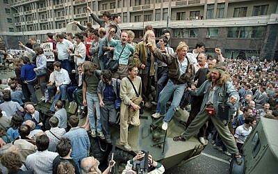 FILE - In this Aug. 19, 1991 file photo, crowds of people surround and climb on tanks which were stopped by the crowd as they drove towards the Red Square area of Moscow, Russia, during a military coup after the announced ousting of Mikhail Gorbachev from power. (AP/Boris Yurchenko, file)