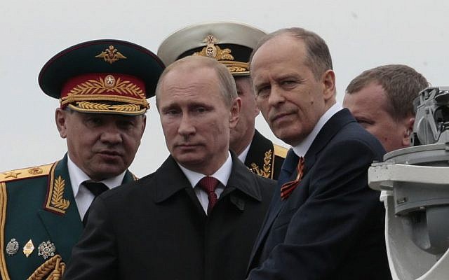 In this file photo taken on Friday, May 9, 2014, Russian President Vladimir Putin, center, flanked by Defense Minister Sergei Shoigu, left, and Federal Security Service Chief Alexander Bortnikov, right, arrives on a boat after inspecting battleships during a navy parade marking Victory Day in Sevastopol, Crimea. (AP Photo/Ivan Sekretarev, File) In this file photo taken on Friday, May 9, 2014, Russian President Vladimir Putin, center, flanked by Defense Minister Sergei Shoigu, left, and Federal Security Service Chief Alexander Bortnikov, right, arrives on a boat after inspecting battleships during a navy parade marking Victory Day in Sevastopol, Crimea. (AP Photo/Ivan Sekretarev, File)