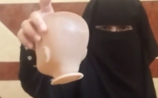 A child holds up the head of a recently beheaded doll in a video disseminated online by an Islamic State sympathizer on August 4, 2016. (screen capture: MEMRI) A child holds up the head of a recently beheaded doll in a video disseminated online by an Islamic State sympathizer on August 4, 2016. (screen capture: MEMRI)