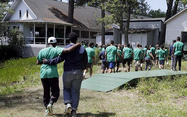 In this Aug. 4, 2016 photo, teens walk together to lunch at the Seeds of Peace camp in Otisfield, Maine. (AP Photo/Elise Amendola) 