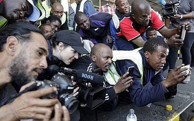 Airport cargo workers and photographers catch a glimpse of tiger Laziz, rescued from a zoo in Gaza, upon its arrival at O.R Tambo international airport in Johannesburg, South Africa, Thursday, Aug. 25, 2016. AP Photo/Themba Hadebe Airport cargo workers and photographers catch a glimpse of tiger Laziz, rescued from a zoo in Gaza, upon its arrival at O.R Tambo international airport in Johannesburg, South Africa, Thursday, Aug. 25, 2016. AP Photo/Themba Hadebe