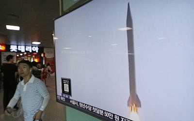 A man passes by a TV news program with file footage of a North Korean rocket launch at the Seoul Railway Station in Seoul, South Korea, August 3, 2016. (AP/Ahn Young-joon)