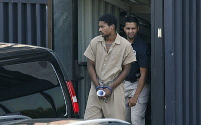 Emanuel Lutchman, who pleaded guilty to conspiracy to support the Islamic State, is transported out of a federal building in Rochester, New York, on August 11, 2016. (Carlos Ortiz/Democrat & Chronicle via AP)