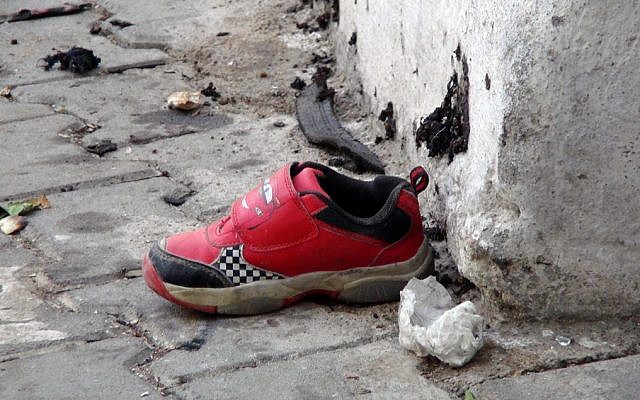 The shoe of a young victim and a piece of metal lay near the scene just hours after Saturday's bomb attack in Gaziantep, southeastern Turkey, early Sunday, Aug. 21, 2016, targeting an outdoor wedding party in southeastern Turkey killing dozens of people and wounding dozens more. (IHA via AP) The shoe of a young victim and a piece of metal lay near the scene just hours after Saturday's bomb attack in Gaziantep, southeastern Turkey, early Sunday, Aug. 21, 2016, targeting an outdoor wedding party in southeastern Turkey killing dozens of people and wounding dozens more. (IHA via AP)