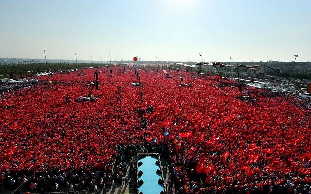 Turkish people wave flags of their country as they take part in a Democracy and Martyrs' Rally in Istanbul, August. 7, 2016. (Kayhan Ozer/Presidential Press Service via AP)