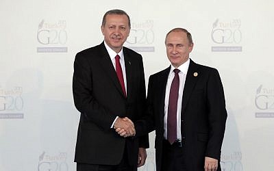 Turkish President Recep Tayyip Erdogan, left, welcomes Russian President Vladimir Putin, at the G-20 summit in Antalya, Turkey, Nov. 15, 2015. (AP Photo/Lefteris Pitarakis, file)