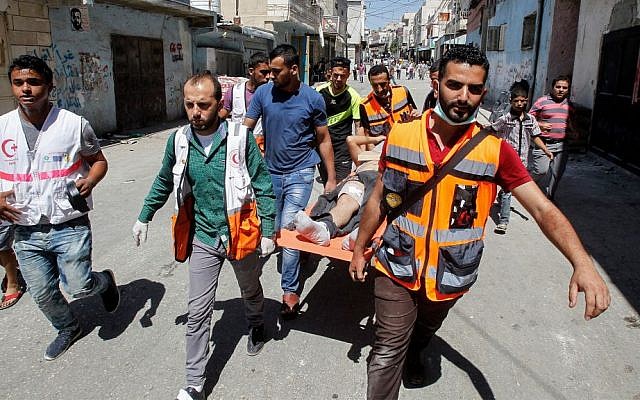 A wounded Palestinian is evacuated during clashes with the IDF in Al-Fawwar refugee camp south of Hebron, August 16 2016. (Wisam Hashlamoun/Flash90) A wounded Palestinian is evacuated during clashes with the IDF in Al-Fawwar refugee camp south of Hebron, August 16 2016. (Wisam Hashlamoun/Flash90)