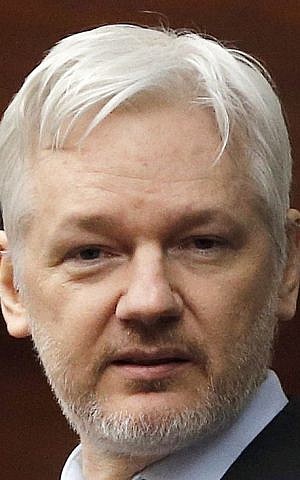 WikiLeaks founder Julian Assange stands on the balcony of the Ecuadorean Embassy in London, February 5, 2016. (AP Photo/Frank Augstein, File)