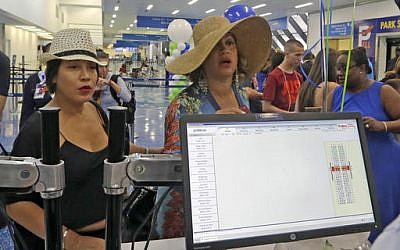 New Yorkers Michelle Sanchez-Boyce (L) and Erika Munro Kennerly check in at the Fort Lauderdale-Hollywood International Airport in Florida ahead of their flight to Santa Clara, Cuba on Wednesday, Aug. 31, 2016 (AP Photo/Alan Diaz)