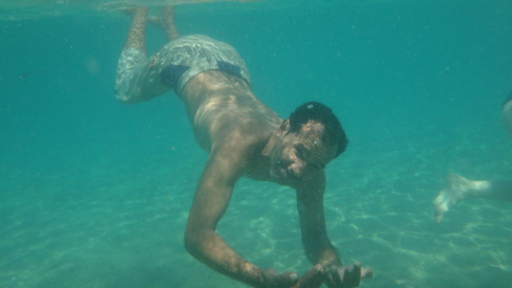 Salman Areb, 38, the accountant and kitchen manager at the Big Dune Camp, takes a swim on August 15, 2016 (courtesy Yuval Saidman).