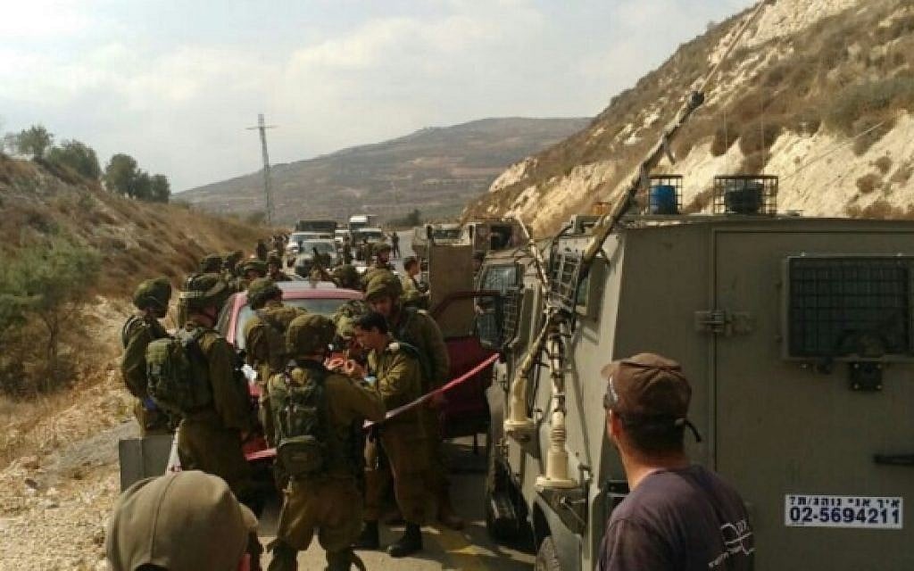 IDF troops attend the scene of a stabbing in the West Bank on August 24, 2016, in which a soldier was lightly hurt. (photo credit: Hatzalah Yehuda & Shomron)