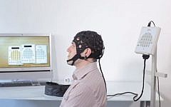 A person wearing an EEG cap (screen capture: YouTube)