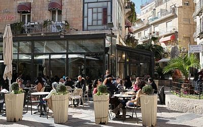 Israelis enjoy the sun as they sit outside at Cafe Rimon in downtown Jerusalem on January 14, 2013. (Nati Shohat/Flash90)