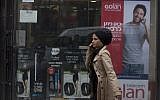A woman walks next to an advertisement  for Golan Telecom in Jerusalem on November 05, 2015. Photo by Lior Mizrahi/Flash90