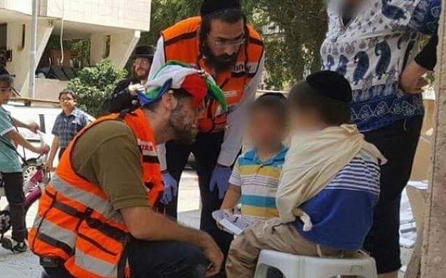 Medic Daniel Klughaupt dons his clown costume when treating an Israeli boy who was hit by a minibus in central Israel, on Thursday August 11 2016. (Courtesy United Hatzalah) Medic Daniel Klughaupt dons his clown costume when treating an Israeli boy who was hit by a minibus in central Israel, on Thursday August 11 2016. (Courtesy United Hatzalah)