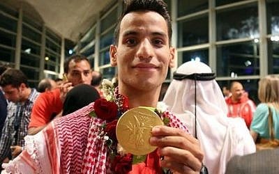 Jordan's first Olympic champion Ahmad Abughaush shows off his taekwondo gold medal at the Queen Alia International Airport in Amman, Jordan, August 23, 2016. AP /Raad Adayleh Jordan's first Olympic champion Ahmad Abughaush shows off his taekwondo gold medal at the Queen Alia International Airport in Amman, Jordan, August 23, 2016. AP /Raad Adayleh