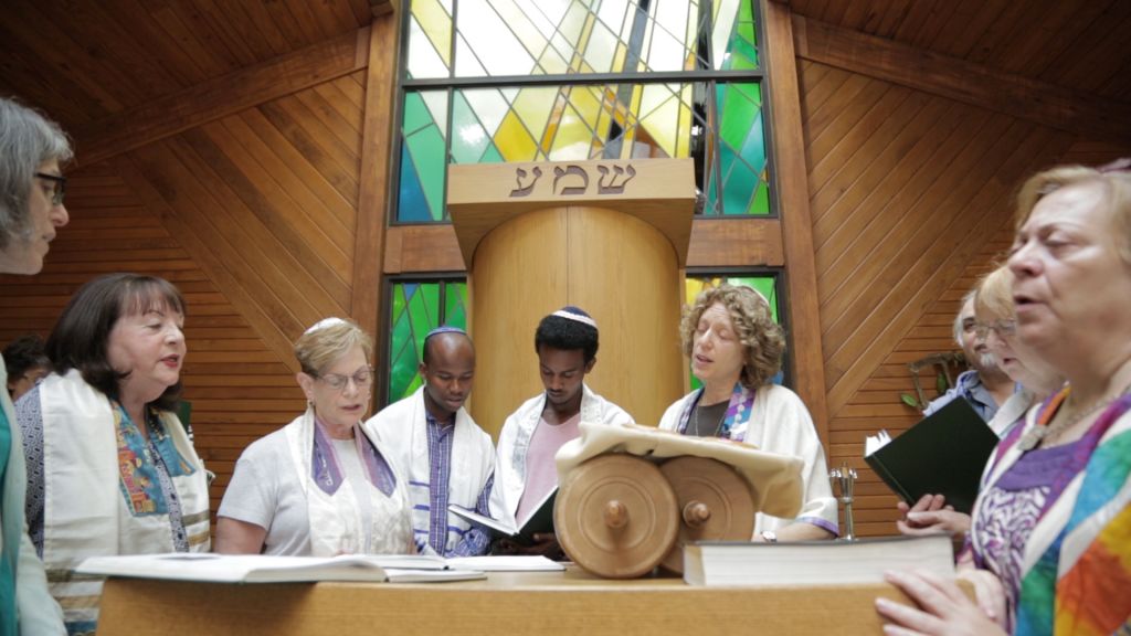 Gezahegn Dereve and Demoz Deboch with Rabbi Shira Milgrom, center right, a co-director of the advocacy efforts, at congregation Kol Ami in White Plains, NY, in July 2016. (courtesy Ryan Porush) 