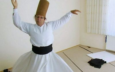 Israeli lecturer Miki Cohen performs the spinning dance of the Mevlevi Order (screen capture: Al Jazeera)