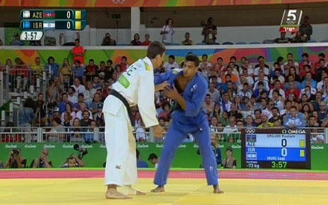 Israel's Sagi Muki (in blue) competes against Rustam Orujov of Azerbaijan in the semifinals of the men's under 73kg judo competition at the Olympic Games in Rio on August 8, 2016 (screen shot: Channel 56) Israel's Sagi Muki (in blue) competes against Rustam Orujov of Azerbaijan in the semifinals of the men's under 73kg judo competition at the Olympic Games in Rio on August 8, 2016 (screen shot: Channel 56)