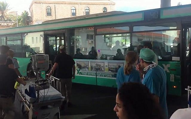 Medical staff wait to treat a woman who is taken to Rambam Hospital by a driver after she falls ill on his Egged bus on August 11, 2016. (photo credit: Rambam Hospital)