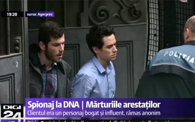 David Geclowitz and Ron Weiner, employees of the Israeli private intelligence firm Black Cube, being brought to the appeals court in Bucharest, after their arrest on suspicion of spying on the country's chief anti-corruption persecutor, April 12, 2016. (screen capture: YouTube)