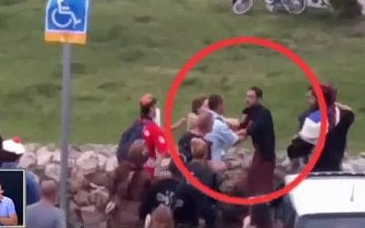 Police are confronted by costumed party-goers during a Purim party in Jerusalem in March 2016 (Channel 10 News)