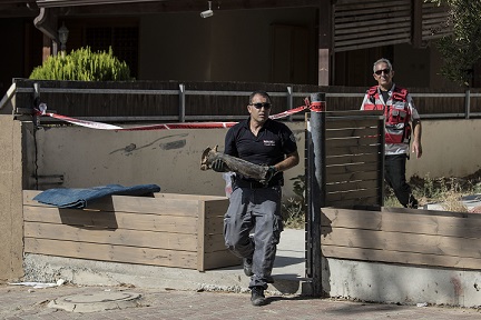An Israeli police sapper carries part of a rocket fired by Palestinian militants in the Gaza Strip from the yard of a house in the city of Sderot, southern Israel, Sunday, August 21, 2016. AP /Tsafrir Abayov. An Israeli police sapper carries part of a rocket fired by Palestinian militants in the Gaza Strip from the yard of a house in the city of Sderot, southern Israel, Sunday, August 21, 2016. AP /Tsafrir Abayov.