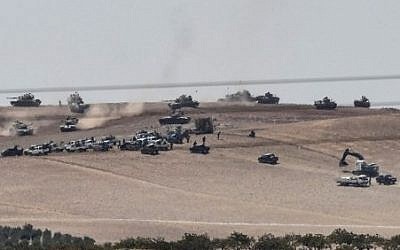 This picture taken from the Turkish Syrian border city of Karkamis in the southern region of Gaziantep, on August 24, 2016 shows Turkish army tanks and pro-Ankara Syrian opposition fighters moving two kilometres west from the Syrian Turkish border town of Jarabulus. AFP/ Bulent Kilic This picture taken from the Turkish Syrian border city of Karkamis in the southern region of Gaziantep, on August 24, 2016 shows Turkish army tanks and pro-Ankara Syrian opposition fighters moving two kilometres west from the Syrian Turkish border town of Jarabulus. AFP/ Bulent Kilic