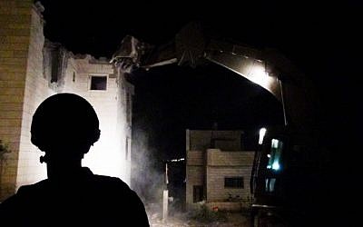 An Israeli excavator demolishes the top floor of the building where Muhammad Muhamra, a terrorist who carried out a deadly shooting attack in Tel Aviv's Sarona Market, lived on August 4, 2016. (IDF Spokesperson's Unit) An Israeli excavator demolishes the top floor of the building where Muhammad Muhamra, a terrorist who carried out a deadly shooting attack in Tel Aviv's Sarona Market, lived on August 4, 2016. (IDF Spokesperson's Unit)