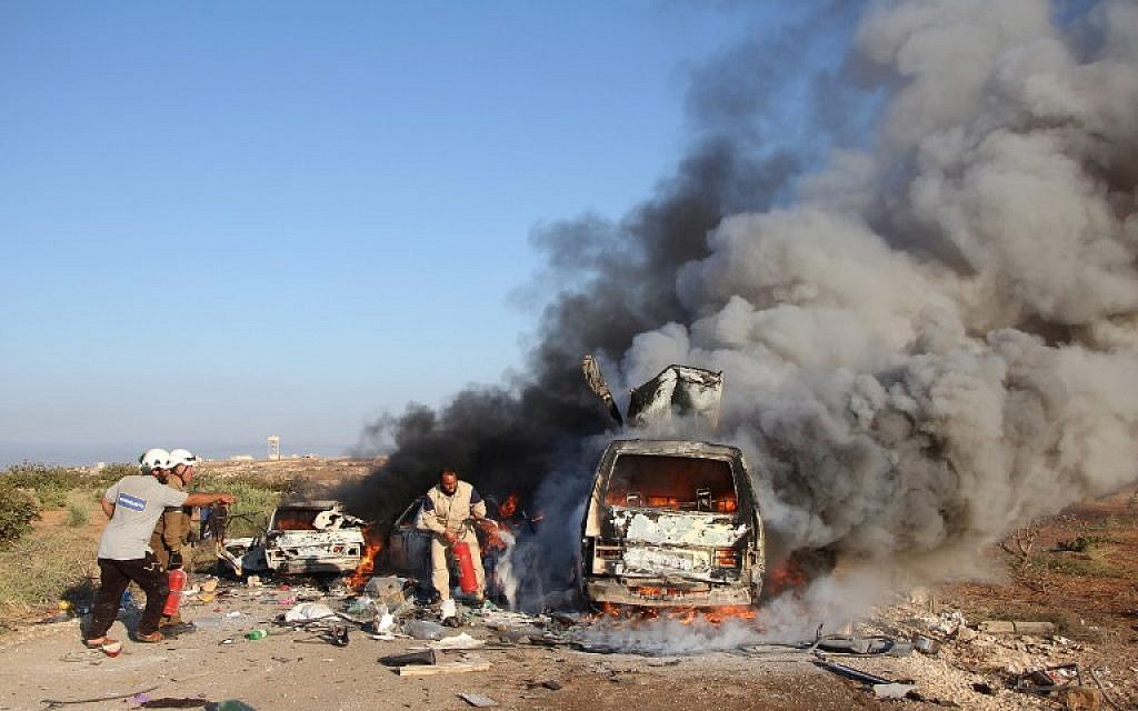 Syrian Civil Defense members, known as the White Helmets, search for survivors amid burning vehicles belonging to people fleeing in northern Hama, after they were reportedly targeted by a Syrian government forces air strike on September 1, 2016. (AFP Photo/Omar Haj Kadour) Syrian Civil Defense members, known as the White Helmets, search for survivors amid burning vehicles belonging to people fleeing in northern Hama, after they were reportedly targeted by a Syrian government forces air strike on September 1, 2016. (AFP Photo/Omar Haj Kadour)