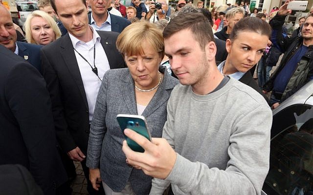German Chancellor Angela Merkel poses for a selfie with a young man at a Christian Democratic Union party campaign on the eve of state election in Mecklenburg-Western Pomerania, in Bad Doberan, eastern Germany, on September 3, 2016. (AFP / Adam BERRY) German Chancellor Angela Merkel poses for a selfie with a young man at a Christian Democratic Union party campaign on the eve of state election in Mecklenburg-Western Pomerania, in Bad Doberan, eastern Germany, on September 3, 2016. (AFP / Adam BERRY)