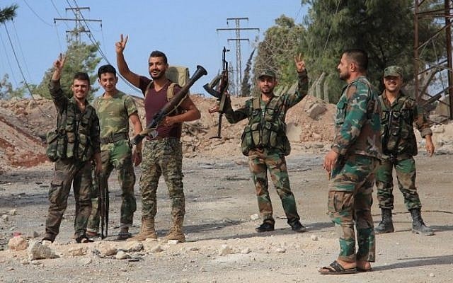 File: Syrian soldiers gesture on September 4, 2016 at a location on the southern outskirts of the Syrian city of Aleppo after regime forces retook control of three military academies from rebel fighters. (AFP/George Ourfalian) File: Syrian soldiers gesture on September 4, 2016 at a location on the southern outskirts of the Syrian city of Aleppo after regime forces retook control of three military academies from rebel fighters. (AFP/George Ourfalian)