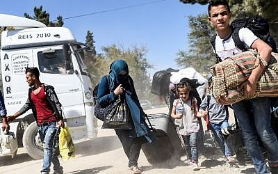 Syrian refugees walk on their way back to the Syrian city of Jarabulus on September 7, 2016 at Karkamis crossing gate, in the southern region of Kilis, Turkey. (AFP/Bulent Kilic)