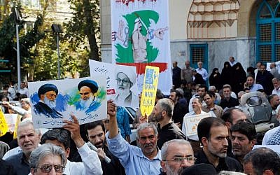 Iranians hold portraits of Iran's Supreme Leader Khamenei (L), Bahraini Shiite cleric Sheikh Isa Qassim (C) and the founder of the Islamic republic Ayatollah Khomeini (R) during an anti-Saudi demonstration in Tehran on September 9, 2016. (AFP PHOTO/STR)