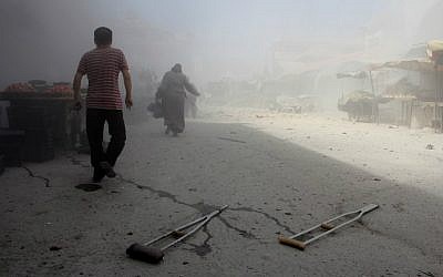 Syrians run away from the scene of a reported air strike on the rebel-held northwestern city of Idlib on September 10, 2016. (Omar Haj Kadour/AFP)