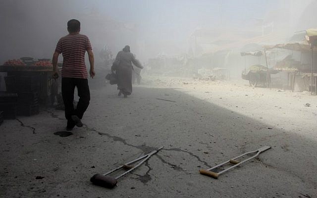 Syrians run away from the scene of a reported air strike on the rebel-held northwestern city of Idlib on September 10, 2016. (Omar Haj Kadour/AFP) Syrians run away from the scene of a reported air strike on the rebel-held northwestern city of Idlib on September 10, 2016. (Omar Haj Kadour/AFP)