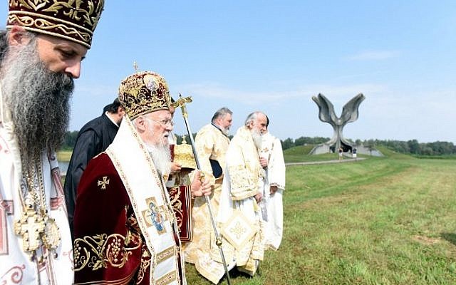 Ecumenical Patriarch Bartholomew I of Constantinople (2L), considered as the spiritual head of Constantinople Patriarchate's Orthodox Christians, is pictured near the Stone Flower monument for the victims of the Jasenovac concentration camp as he visits the site of the former camp in Jasenovac, Croatia on September 10, 2016. (AFP PHOTO / STR) Ecumenical Patriarch Bartholomew I of Constantinople (2L), considered as the spiritual head of Constantinople Patriarchate's Orthodox Christians, is pictured near the Stone Flower monument for the victims of the Jasenovac concentration camp as he visits the site of the former camp in Jasenovac, Croatia on September 10, 2016. (AFP PHOTO / STR)