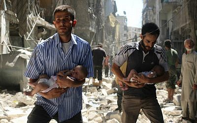 Syrian men carrying babies make their way through the rubble of destroyed buildings following a reported air strike on the rebel-held Salihin neighborhood of the northern city of Aleppo, on September 11, 2016. (Ameer Alhalbi/AFP)