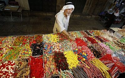 A Palestinian man buys sweets as Muslims shop in preparation for the holiday of Eid al-Adha at the market in the Old City of Jerusalem on September 11, 2016. (AFP PHOTO/HAZEM BADER) 