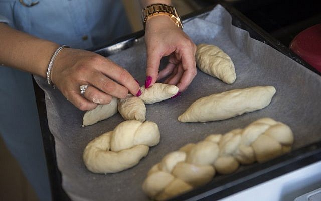 A member of the Jewish community of Porto prepares the bread for the Shabbat festive day in Porto, on September 2, 2016. (AFP PHOTO / MIGUEL RIOPA)