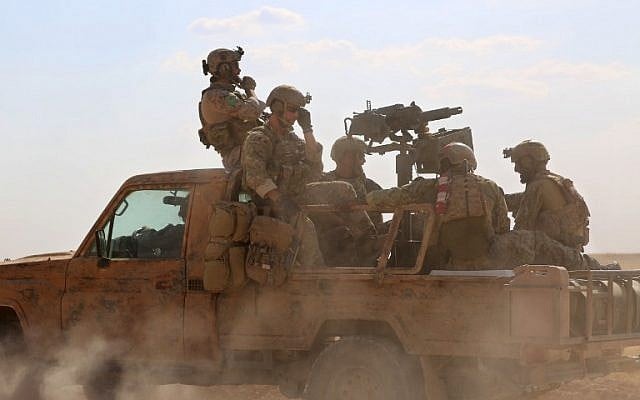 This file photo taken on May 25, 2016 shows armed men in uniform identified by Syrian Democratic forces as US special operations forces riding in the back of a pickup truck in the village of Fatisah in the northern Syrian province of Raqqa. (AFP/Delil Souleiman) This file photo taken on May 25, 2016 shows armed men in uniform identified by Syrian Democratic forces as US special operations forces riding in the back of a pickup truck in the village of Fatisah in the northern Syrian province of Raqqa. (AFP/Delil Souleiman)