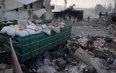 Aid is seen strewn across the ground in the town of Orum al-Kubra on the western outskirts of the northern Syrian city of Aleppo on September 20, 2016, the morning after a convoy delivering aid was hit by a deadly air strike. (AFP PHOTO / Omar Haj Kadour)