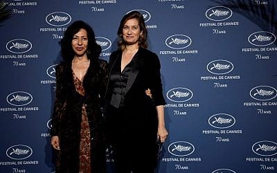 French actress Emmanuelle Devos (R) and writer Yasmina Reza pose as they arrive for a ceremony marking the 70th anniversary of the Cannes International Film Festival on September 20, 2016 in Paris. (AFP PHOTO / PHILIPPE LOPEZ)