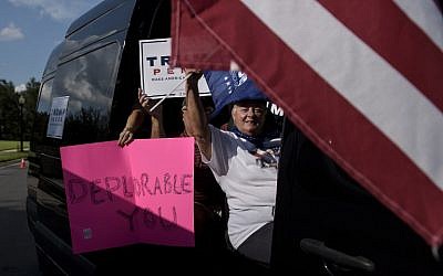 Supporters of Republican presidential nominee Donald Trump drive past a neighborhood as Democratic presidential nominee Hillary Clinton attends a fundraiser on September 21, 2016 in Lake Mary, Florida. (AFP/Brendan Smialowski)