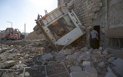 A Syrian rescuer walks amidst destruction following an air strike in the rebel-held Ansari district in the northern city of Aleppo on September 23, 2016. (AFP PHOTO/KARAM AL-MASRI)