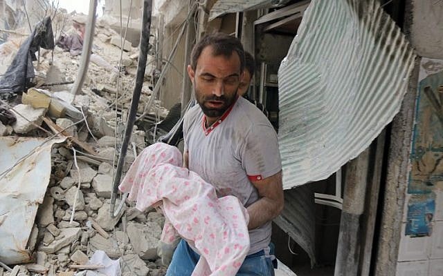 A Syrian man carries the body of an infant retrieved from under the rubble of a building following a reported airstrike on September 23, 2016, on the al-Muasalat area in the northern Syrian city of Aleppo. (AFP PHOTO/THAER MOHAMMED)