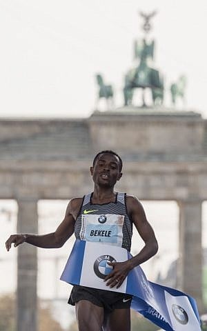 Ethiopian Kenenisa Bekele crosses the finish line to win the 43rd Berlin Marathon in Berlin on September 25, 2016. (AFP PHOTO / John MACDOUGALL)
